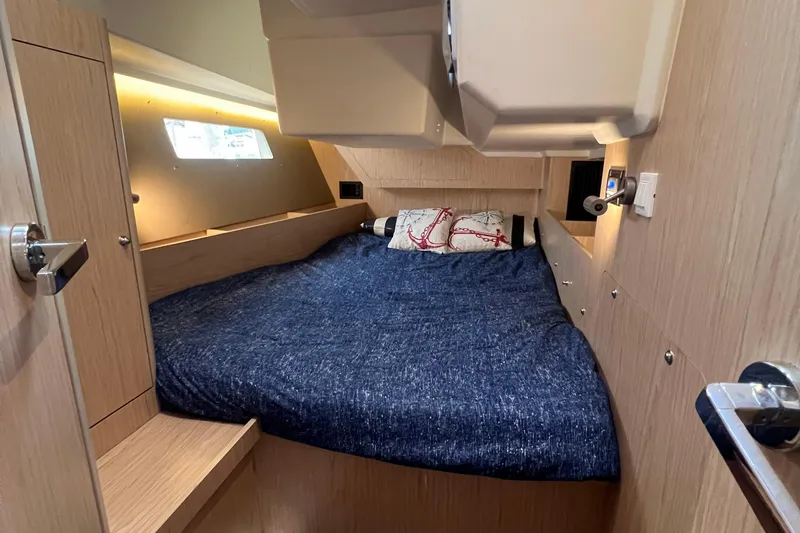 Slide: The Image of Cozy cabin interior of 2019 Beneteau Oceanis 41.1 sailboat with blue bedding. - 6