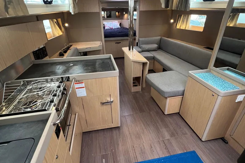 Slide: The Image of Interior of 2019 Beneteau Oceanis 41.1 yacht with modern kitchen and cozy seating area. - 7