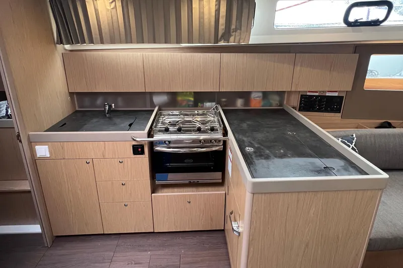 Slide: The Image of Modern kitchen in 2019 Beneteau Oceanis 41.1 yacht with stove and ample storage. - 9