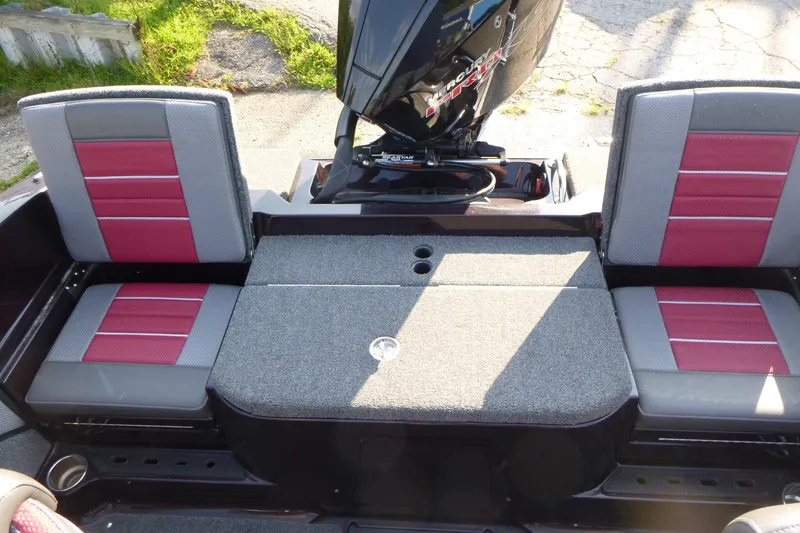 Slide: The Image of 2024 Ranger 2080MS boat interior with red and gray seating and motor. - 13