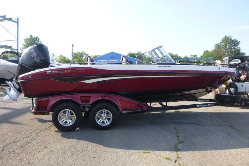 Slide: The Image of 2024 Ranger 2080MS boat on trailer, red and white design, outdoor setting. - 4