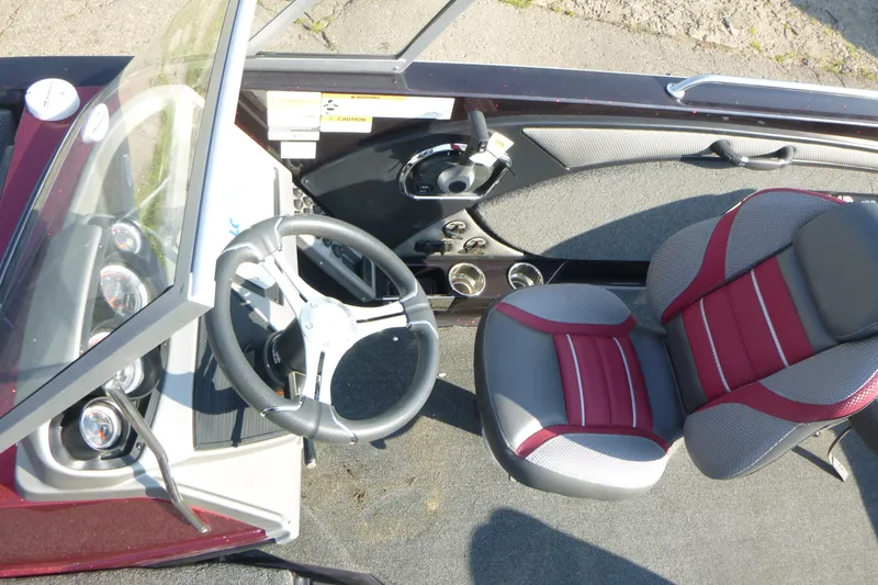 Slide: The Image of 2024 Ranger 2080MS boat interior with steering wheel and red-gray seating. - 7