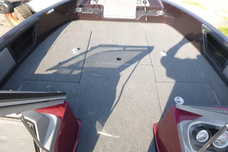 Slide: The Image of 2024 Ranger 2080MS boat interior with spacious carpeted deck and storage compartments. - 9