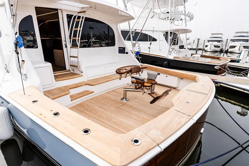 Slide: The Image of 2026 Viking 64 Convertible yacht with spacious teak deck and fishing chair. - 10
