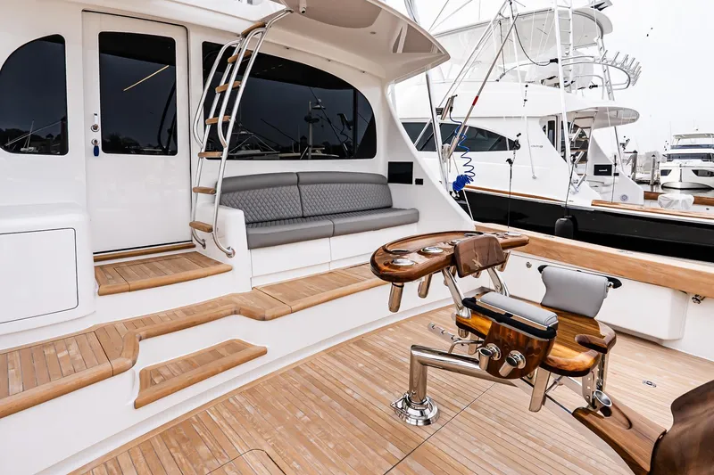 Slide: The Image of 2026 Viking 64 Convertible yacht deck with seating and fishing chair. - 13