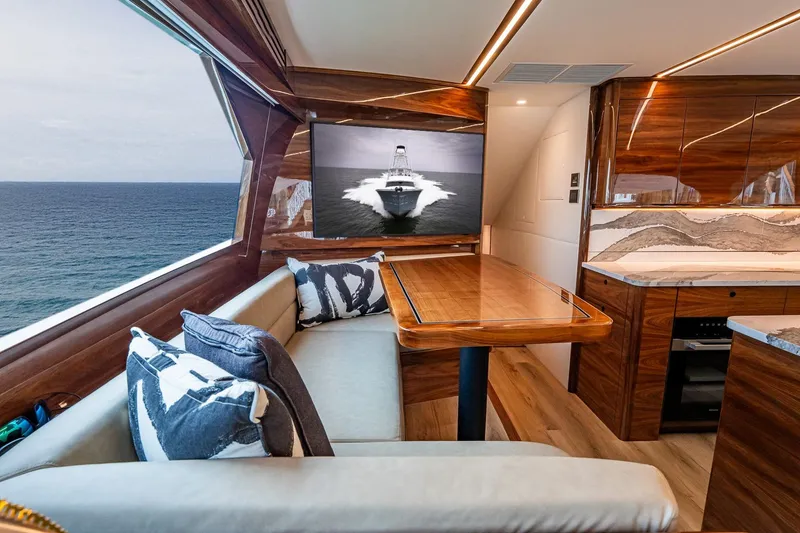 Slide: The Image of Luxurious interior of 2025 Viking 64 Convertible yacht with ocean view and elegant wood finishes. - 26