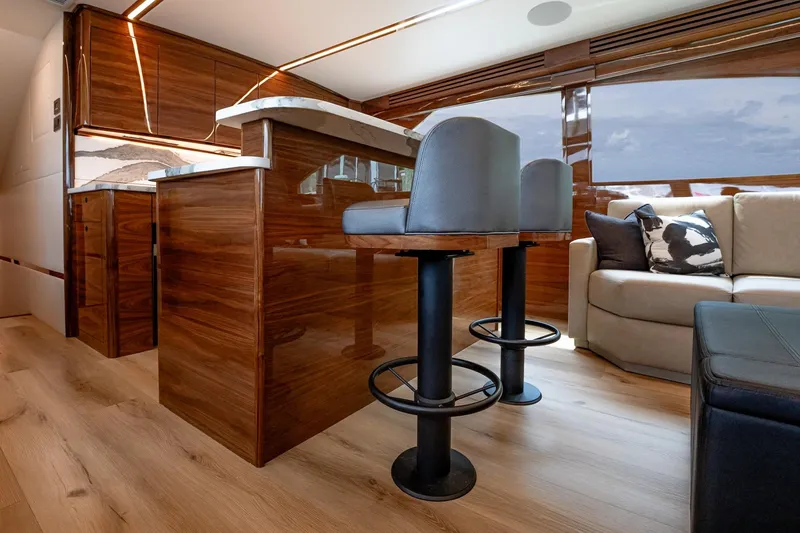 Slide: The Image of Luxurious interior of 2025 Viking 64 Convertible yacht with elegant wood finishes and modern seating. - 28