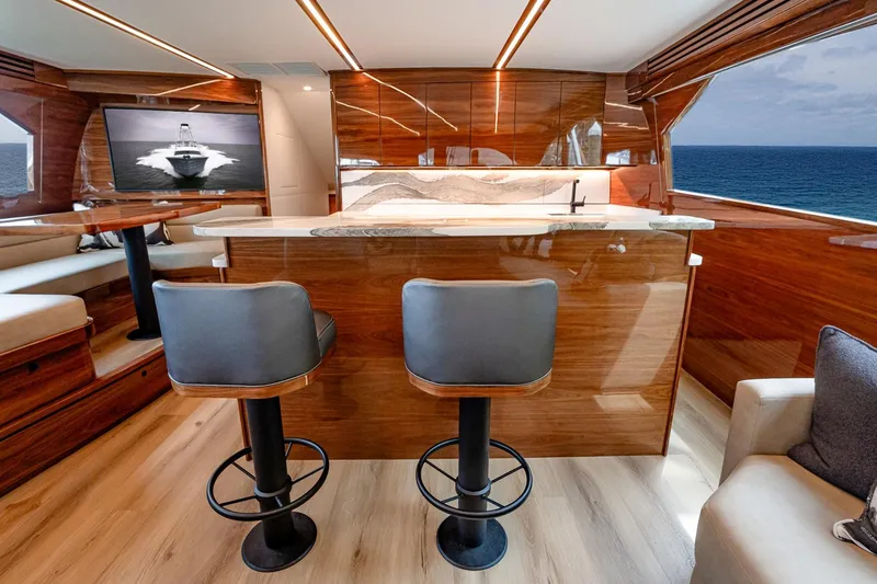 Slide: The Image of Luxurious interior of 2025 Viking 64 Convertible yacht with ocean view and modern furnishings. - 30