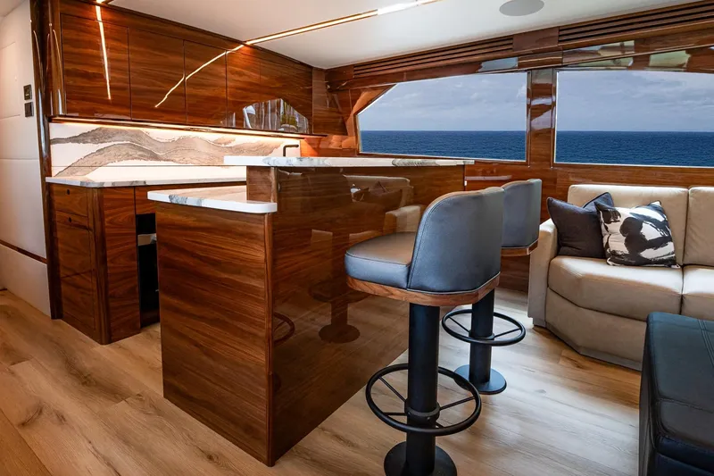 Slide: The Image of Luxurious interior of 2025 Viking 64 Convertible yacht with ocean view and elegant furnishings. - 32
