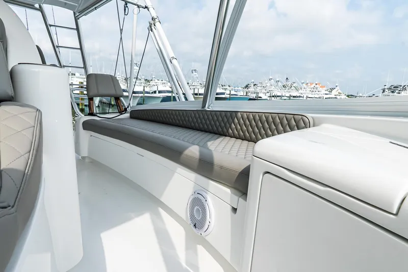 Slide: The Image of Luxurious seating on 2025 Viking 64 Convertible yacht, docked at marina. - 40