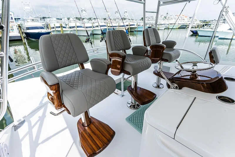 Slide: The Image of Luxurious interior of 2025 Viking 64 Convertible yacht with elegant seating and steering wheel. - 46
