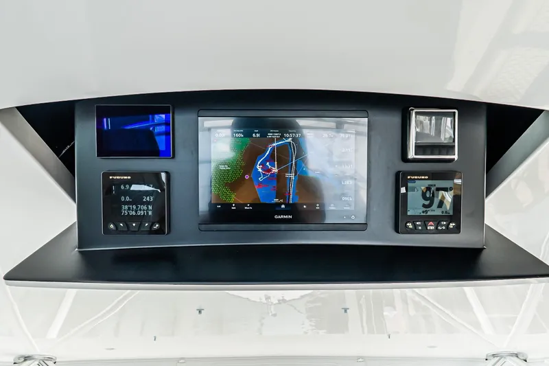 Slide: The Image of 2025 Viking 64 Convertible yacht dashboard with advanced navigation displays. - 52