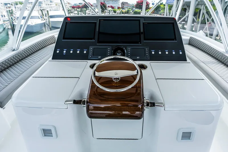 Slide: The Image of 2025 Viking 64 Convertible yacht helm with modern controls and sleek design. - 55