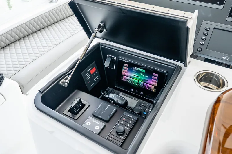 Slide: The Image of 2025 Viking 64 Convertible yacht control panel with advanced navigation and communication systems. - 56