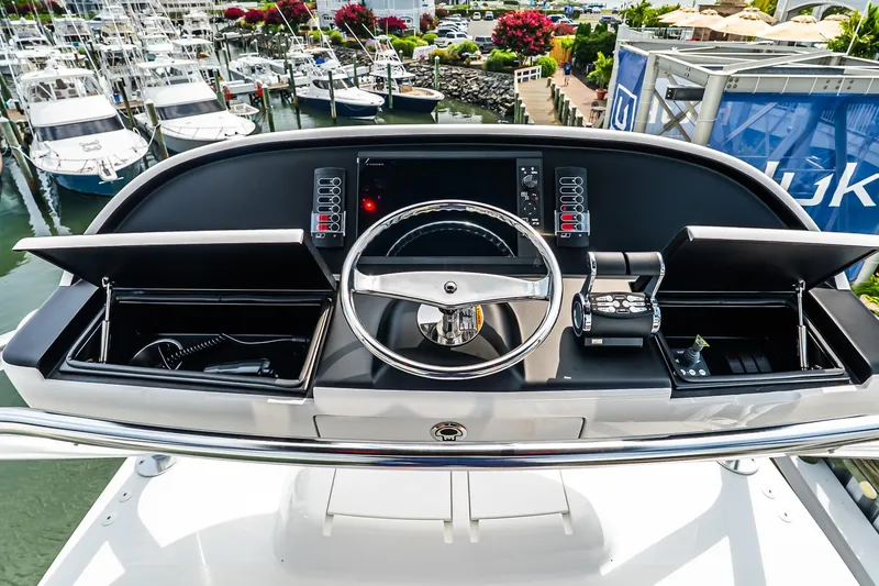 Slide: The Image of Helm of 2025 Viking 64 Convertible yacht with modern controls and steering wheel. - 62
