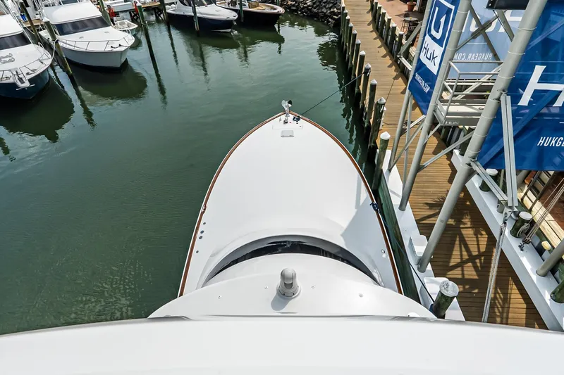 Slide: The Image of Aerial view of 2025 Viking 64 Convertible yacht docked at marina. - 64