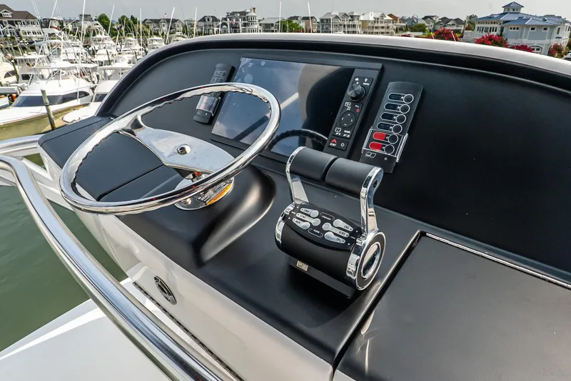 Slide: The Image of Helm of 2025 Viking 64 Convertible yacht with modern controls and steering wheel. - 66