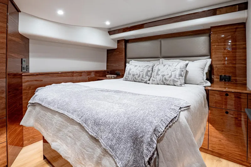Slide: The Image of Luxurious bedroom interior of 2026 Viking 64 Convertible yacht with elegant wood finishes. - 68