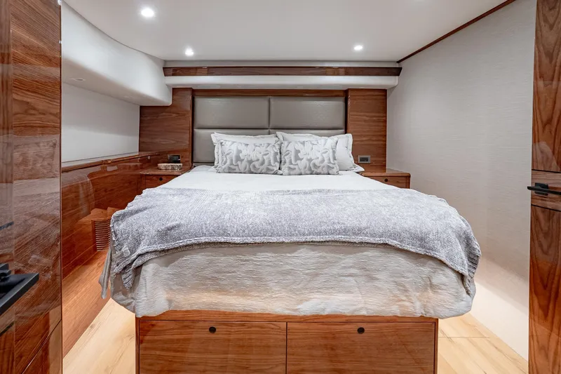 Slide: The Image of Luxurious bedroom interior of 2026 Viking 64 Convertible yacht with elegant wood finishes. - 69