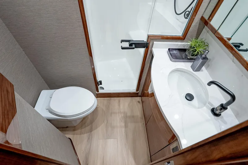 Slide: The Image of Luxurious bathroom in 2026 Viking 64 Convertible yacht with modern fixtures and elegant design. - 71