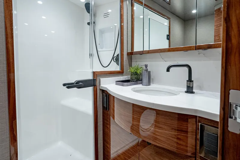 Slide: The Image of Luxurious bathroom in 2026 Viking 64 Convertible yacht with modern fixtures and elegant design. - 72