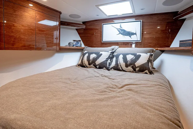 Slide: The Image of Luxurious bedroom interior of 2026 Viking 64 Convertible yacht with elegant wood finishes. - 74