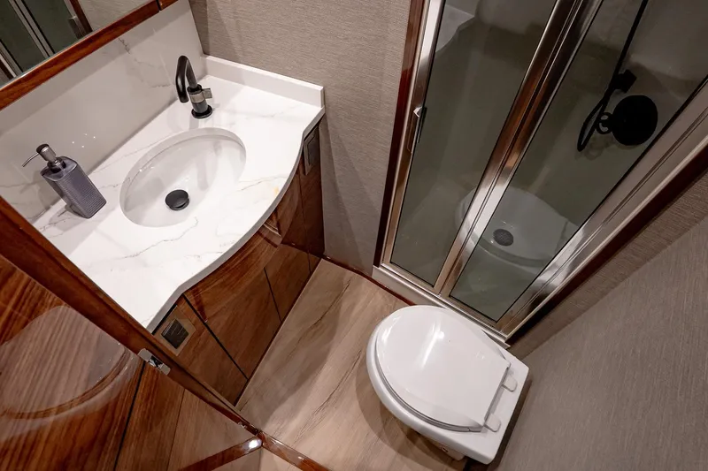 Slide: The Image of Luxurious bathroom in 2026 Viking 64 Convertible yacht with modern fixtures and elegant design. - 75