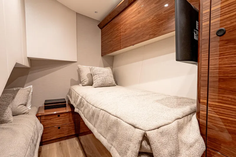 Slide: The Image of Luxurious cabin interior of 2026 Viking 64 Convertible yacht with cozy bedding and wood finishes. - 80