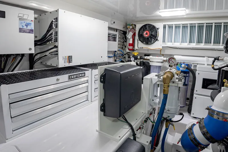 Slide: The Image of Engine room of 2026 Viking 64 Convertible yacht with Craftsman tool storage. - 84