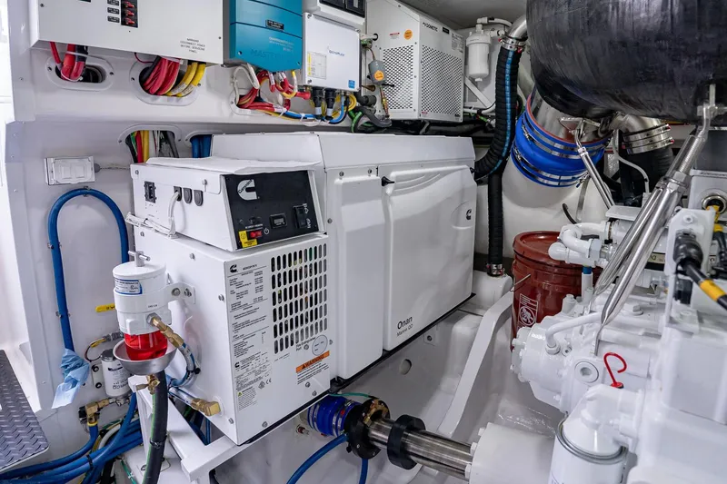 Slide: The Image of Engine room of 2026 Viking 64 Convertible yacht with Onan generator and wiring. - 87