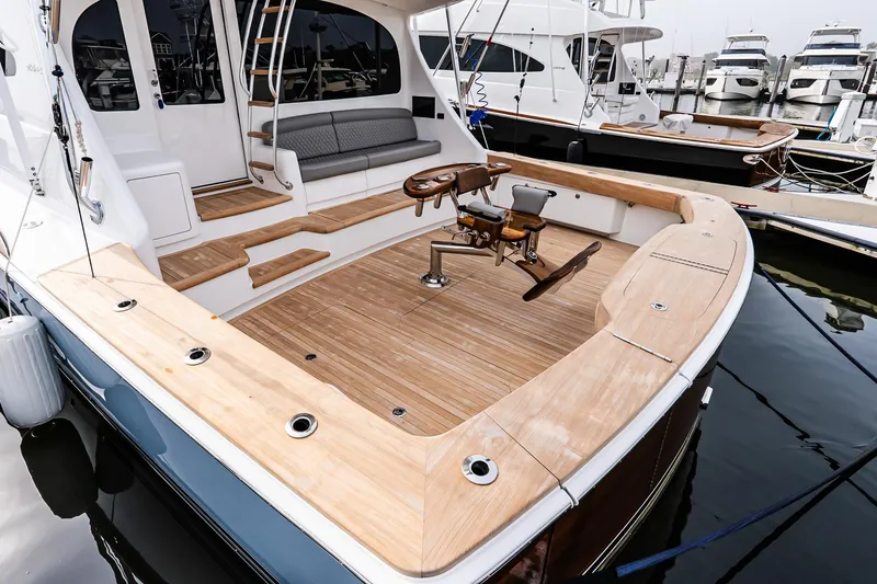 Slide: The Image of 2026 Viking 64 Convertible yacht with spacious teak deck and fishing chair. - 9