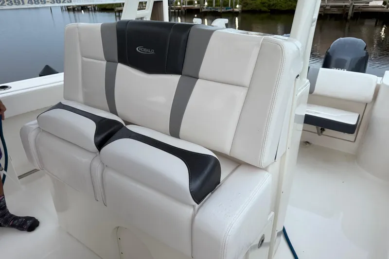 Slide: The Image of 2020 Robalo R272 Center Console boat seating, white and black upholstery. - 12