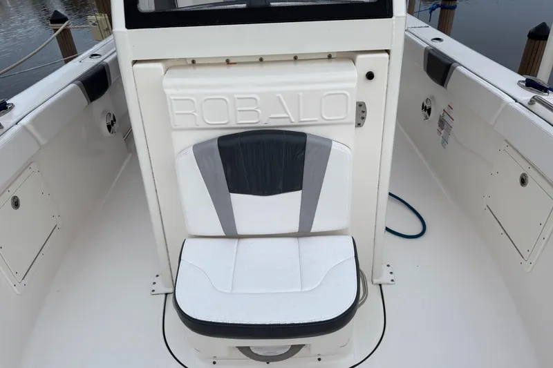 Slide: The Image of 2020 Robalo R272 Center Console boat seat with logo, white and gray design. - 17