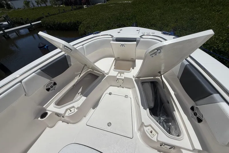 Slide: The Image of 2020 Robalo R272 Center Console boat with open storage compartments and seating area. - 19