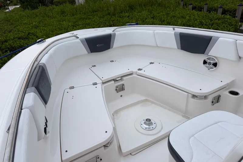 Slide: The Image of 2020 Robalo R272 Center Console boat interior with cushioned seating and storage compartments. - 21
