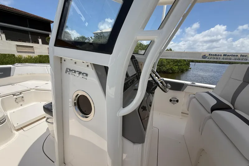 Slide: The Image of 2020 Robalo R272 Center Console boat interior with steering wheel and seating. - 23
