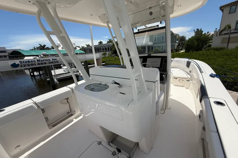 Slide: The Image of 2020 Robalo R272 Center Console boat interior with helm and seating area. - 26