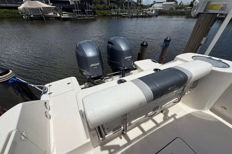 Slide: The Image of 2020 Robalo R272 Center Console boat with twin Yamaha 200 engines docked by the water. - 28