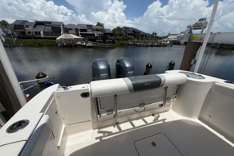 Slide: The Image of 2020 Robalo R272 Center Console boat docked with twin 200 engines, scenic waterfront view. - 29