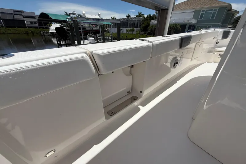 Slide: The Image of 2020 Robalo R272 Center Console boat interior with cushioned seating and storage compartments. - 31