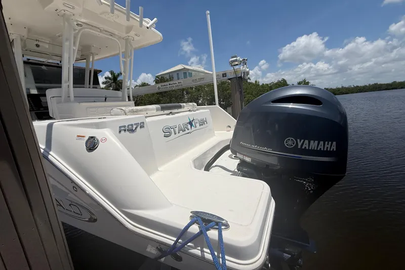 Slide: The Image of 2020 Robalo R272 Center Console boat with Yamaha engine docked by the water. - 33