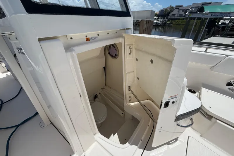 Slide: The Image of 2020 Robalo R272 Center Console boat interior with open storage compartment. - 34