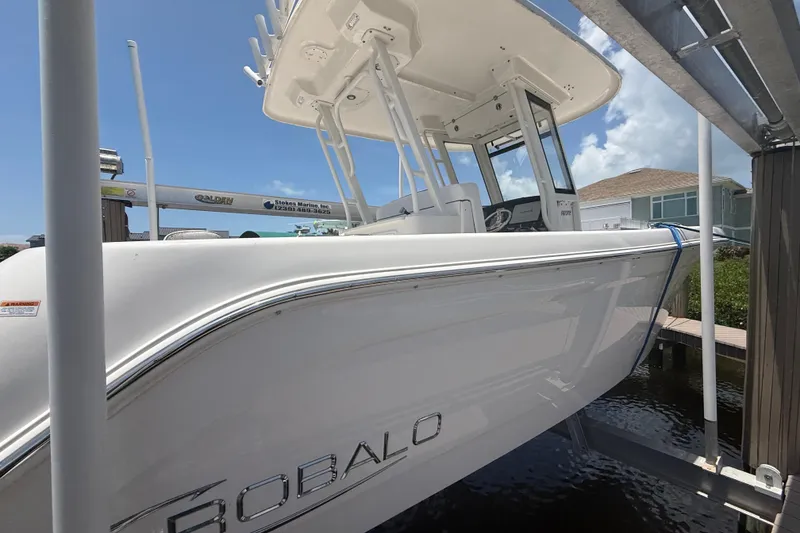 Slide: The Image of 2020 Robalo R272 Center Console boat docked, showcasing sleek design and modern features. - 37