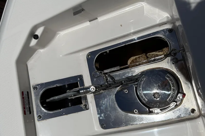 Slide: The Image of Anchor compartment of 2020 Robalo R272 Center Console boat with chain and winch. - 41