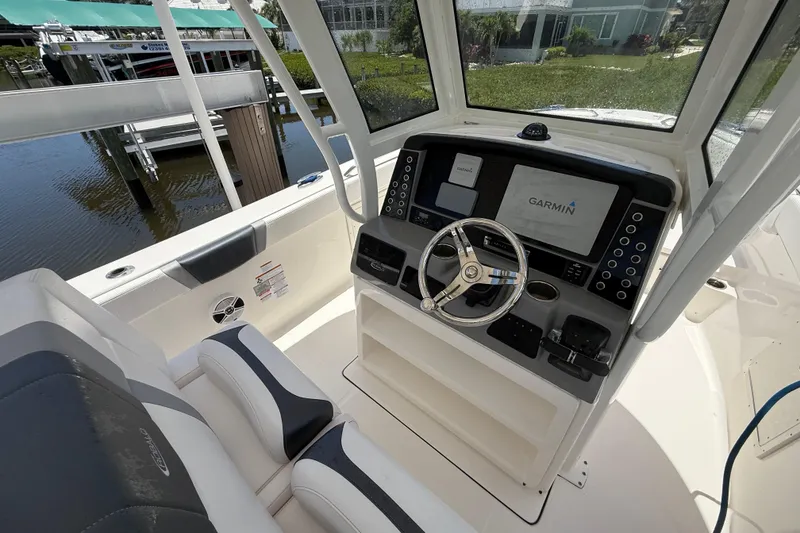 Slide: The Image of 2020 Robalo R272 Center Console boat with Garmin navigation system and sleek interior design. - 8