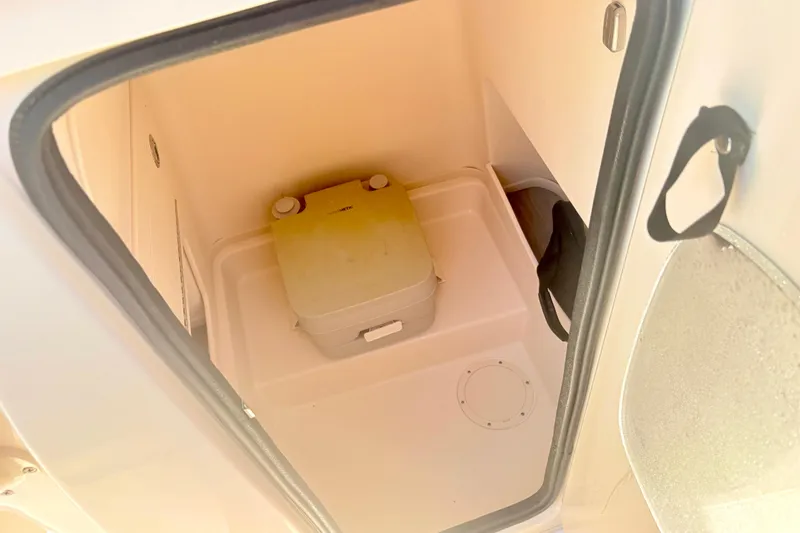 Slide: The Image of Interior of 2022 Grady-White 251 Coastal Explorer boat with portable toilet. - 10