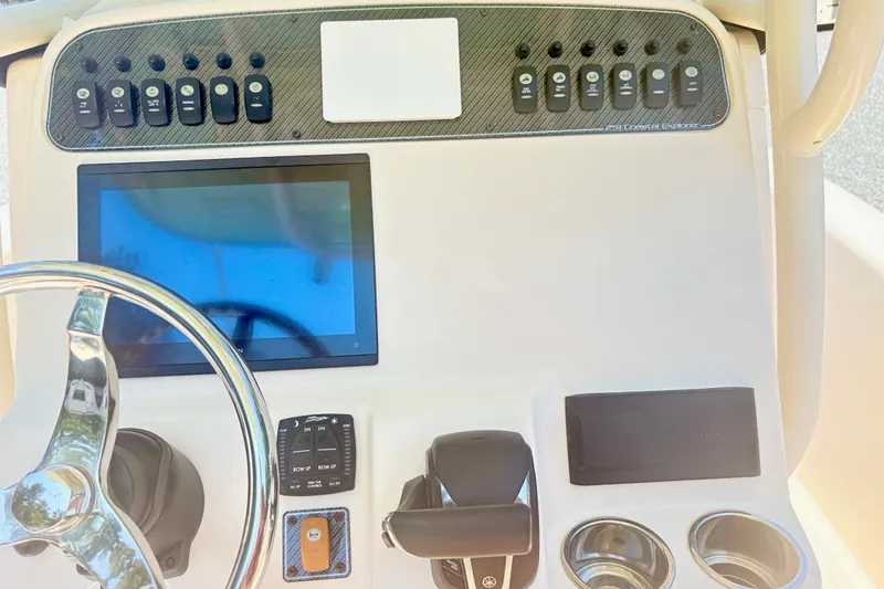 Slide: The Image of 2022 Grady-White 251 Coastal Explorer dashboard with steering wheel and control panel. - 11