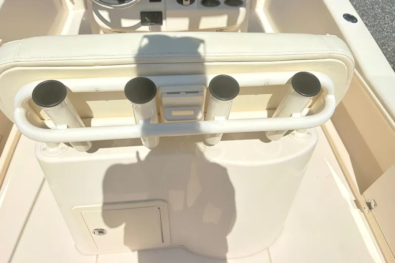 Slide: The Image of 2022 Grady-White 251 Coastal Explorer boat console with rod holders and storage compartment. - 13