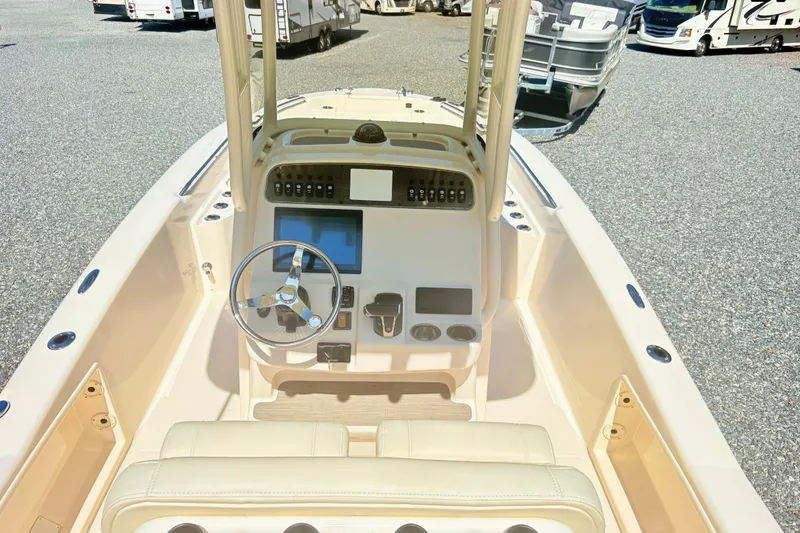 Slide: The Image of 2022 Grady-White 251 Coastal Explorer boat interior with steering console and seating. - 14
