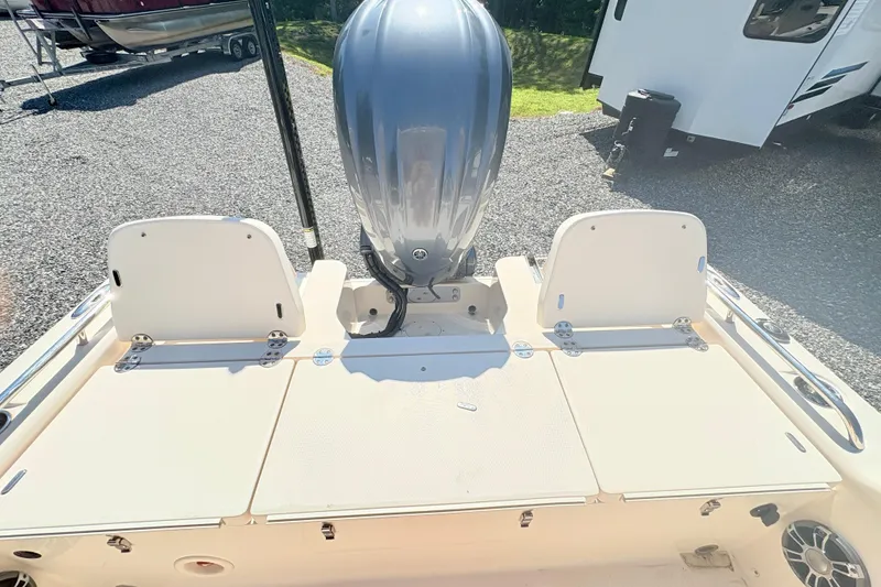 Slide: The Image of 2022 Grady-White 251 Coastal Explorer boat with outboard motor, parked on gravel. - 7